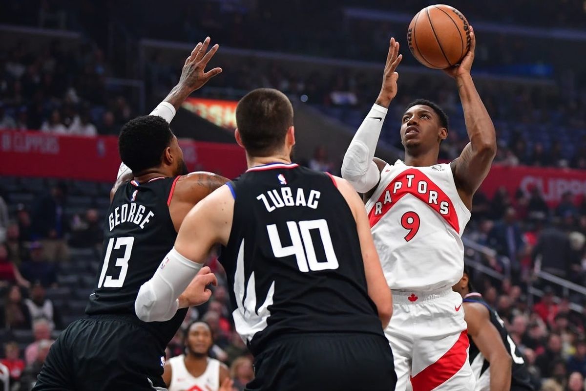 Jan 10, 2024; Los Angeles, California, USA; Toronto Raptors guard RJ Barrett (9) shoots against Los Angeles Clippers forward Paul George (13) and center Ivica Zubac (40) during the first half at Crypto.com Arena.