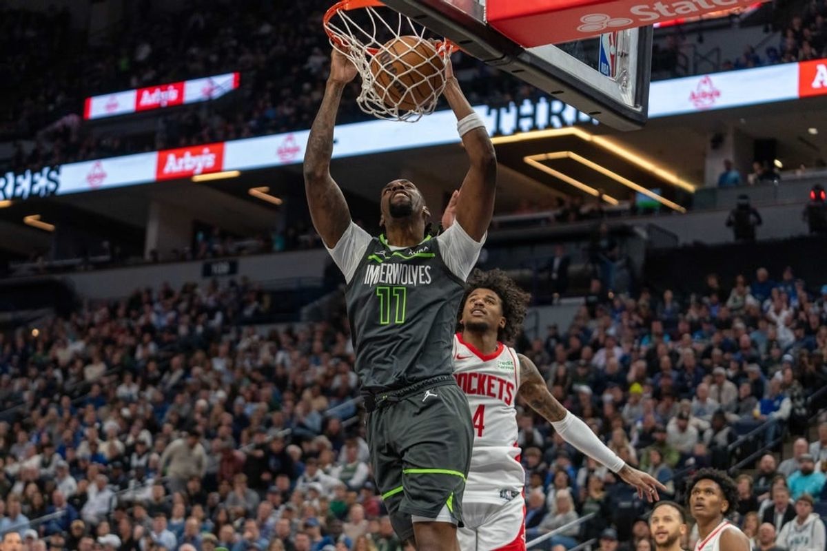 Apr 2, 2024; Minneapolis, Minnesota, USA; Minnesota Timberwolves center Naz Reid (11) dunks over Houston Rockets guard Jalen Green (4) in the second quarter at Target Center.