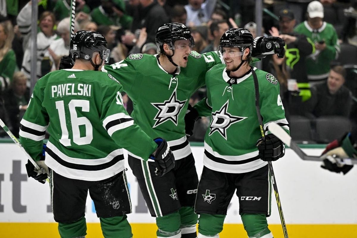Nov 14, 2023; Dallas, Texas, USA; Dallas Stars center Joe Pavelski (16) and center Roope Hintz (24) and defenseman Miro Heiskanen (4) celebrates a power play goal scored by Hintz against the Arizona Coyotes during the second period at the American Airlines Center.