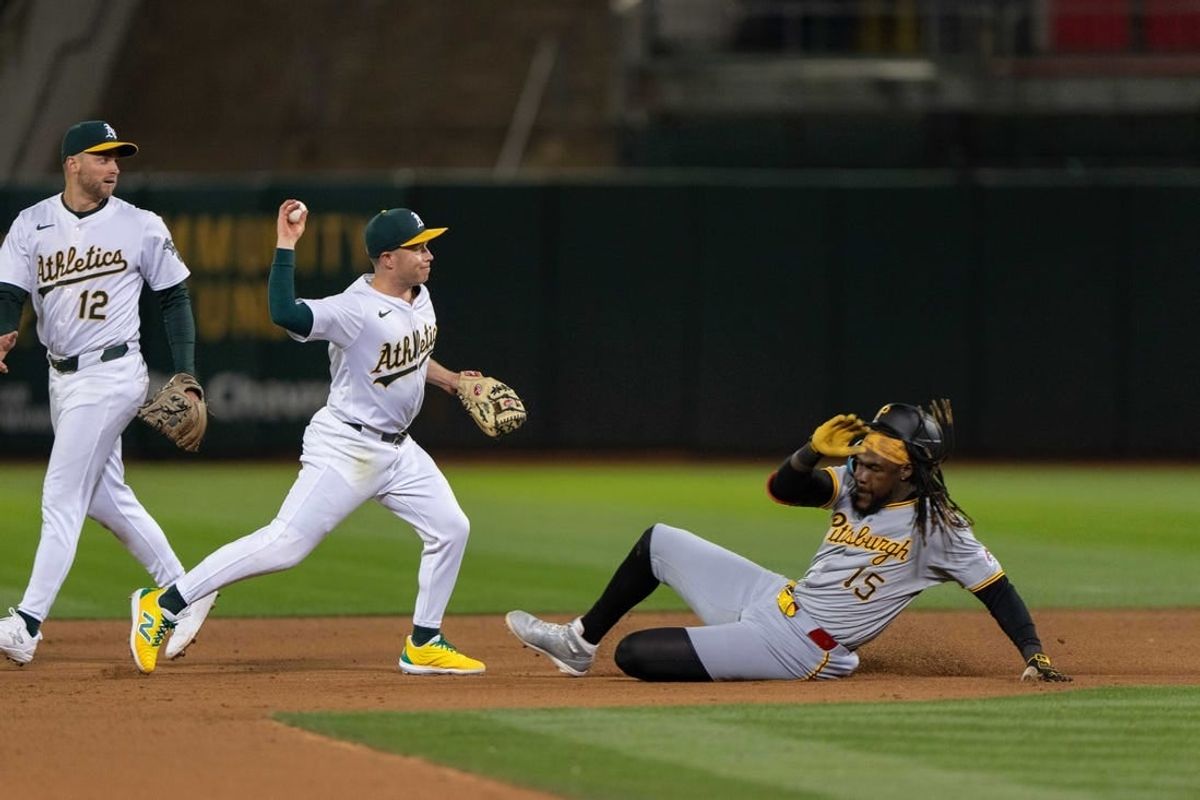 Apr 29, 2024; Oakland, California, USA; Oakland Athletics shortstop Nick Allen (10) throws the ball to first after a force tag on Pittsburgh Pirates shortstop Oneil Cruz (15) during the ninth inning at Oakland-Alameda County Coliseum.