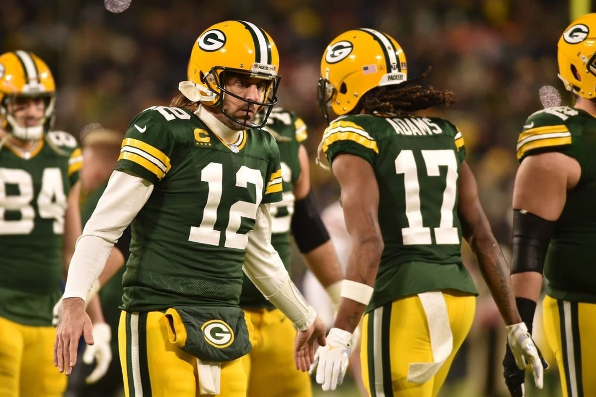 Jan 22, 2022; Green Bay, Wisconsin, USA; Green Bay Packers quarterback Aaron Rodgers (12) and wide receiver Davante Adams (17) in action against the San Francisco 49ers during a NFC Divisional playoff football game at Lambeau Field.
