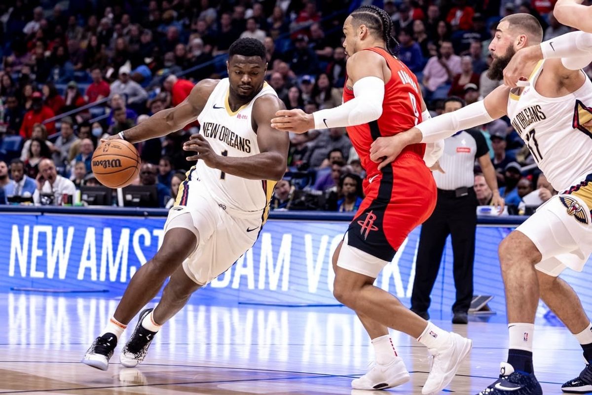 Feb 22, 2024; New Orleans, Louisiana, USA;  New Orleans Pelicans forward Zion Williamson (1) dribbles against Houston Rockets forward Dillon Brooks (9) during the first half at Smoothie King Center.