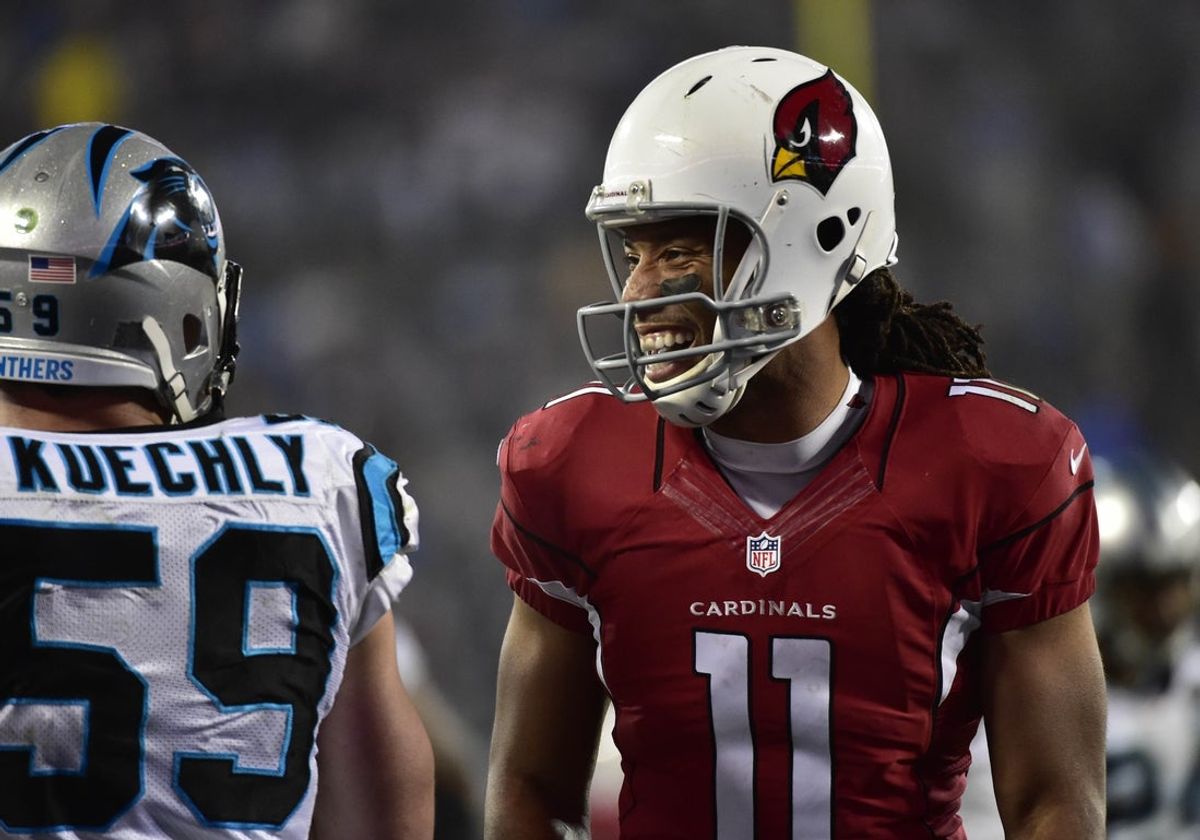 Jan 3, 2015; Charlotte, NC, USA; Carolina Panthers middle linebacker Luke Kuechly (59) and Arizona Cardinals wide receiver Larry Fitzgerald (11) on the field in the 2014 NFC Wild Card playoff football game at Bank of America Stadium. Mandatory Credit: Bob Donnan-Imagn Images