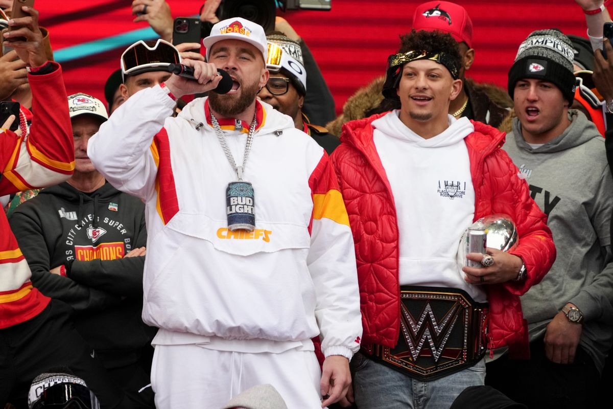 T ravis Kelce and Patrick Mahomes celebrate on stage during the Kansas City Chiefs Super Bowl LVII victory parade.