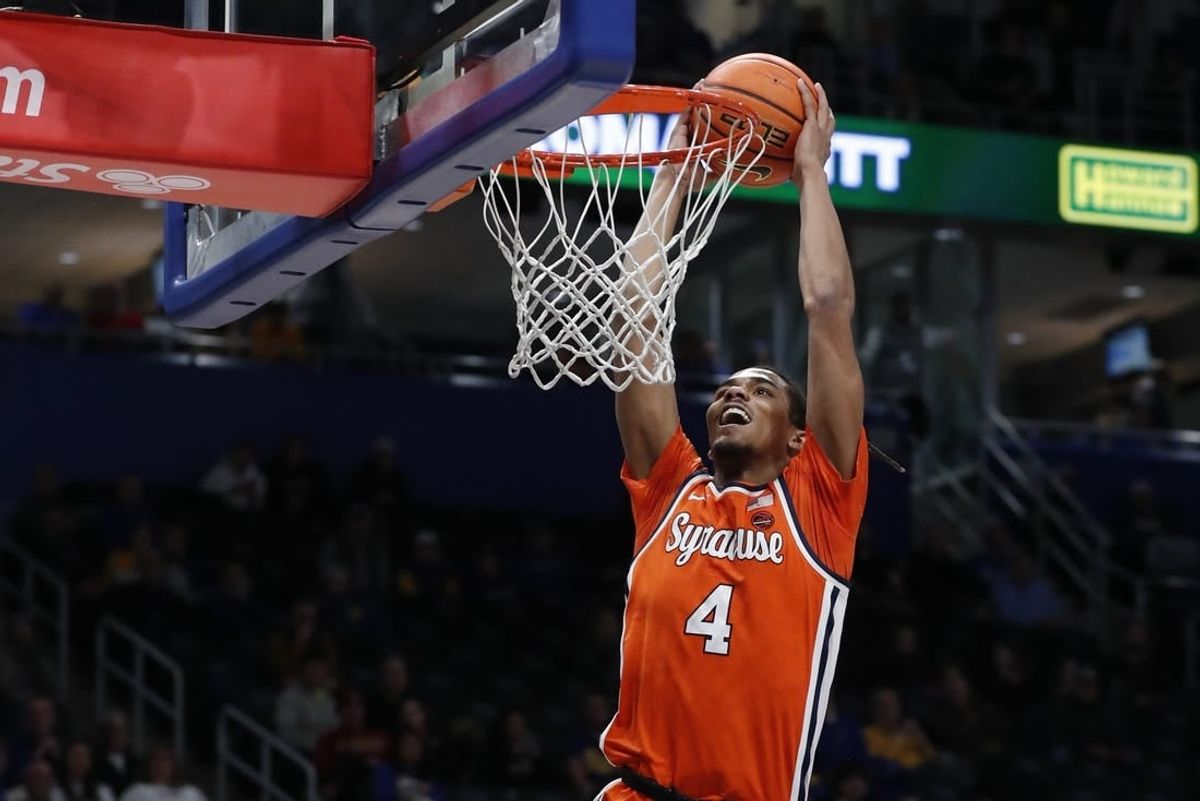 Jan 16, 2024; Pittsburgh, Pennsylvania, USA; Syracuse Orange forward Chris Bell (4) dunks the ball on a breakaway against the Pittsburgh Panthers during the first half at the Petersen Events Center.