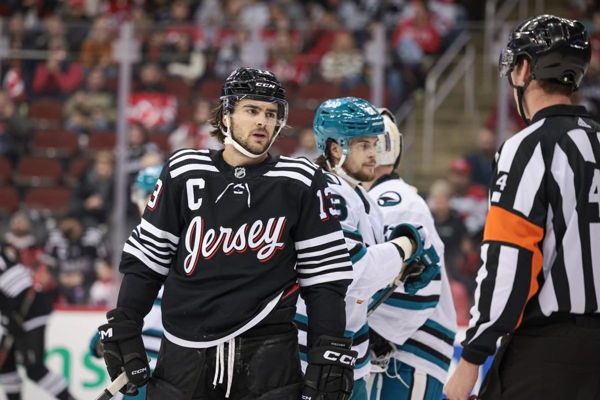 Dec 1, 2023; Newark, New Jersey, USA; New Jersey Devils center Nico Hischier (13) talks with referee Wes McCauley (4) during the first period against the San Jose Sharks at Prudential Center.