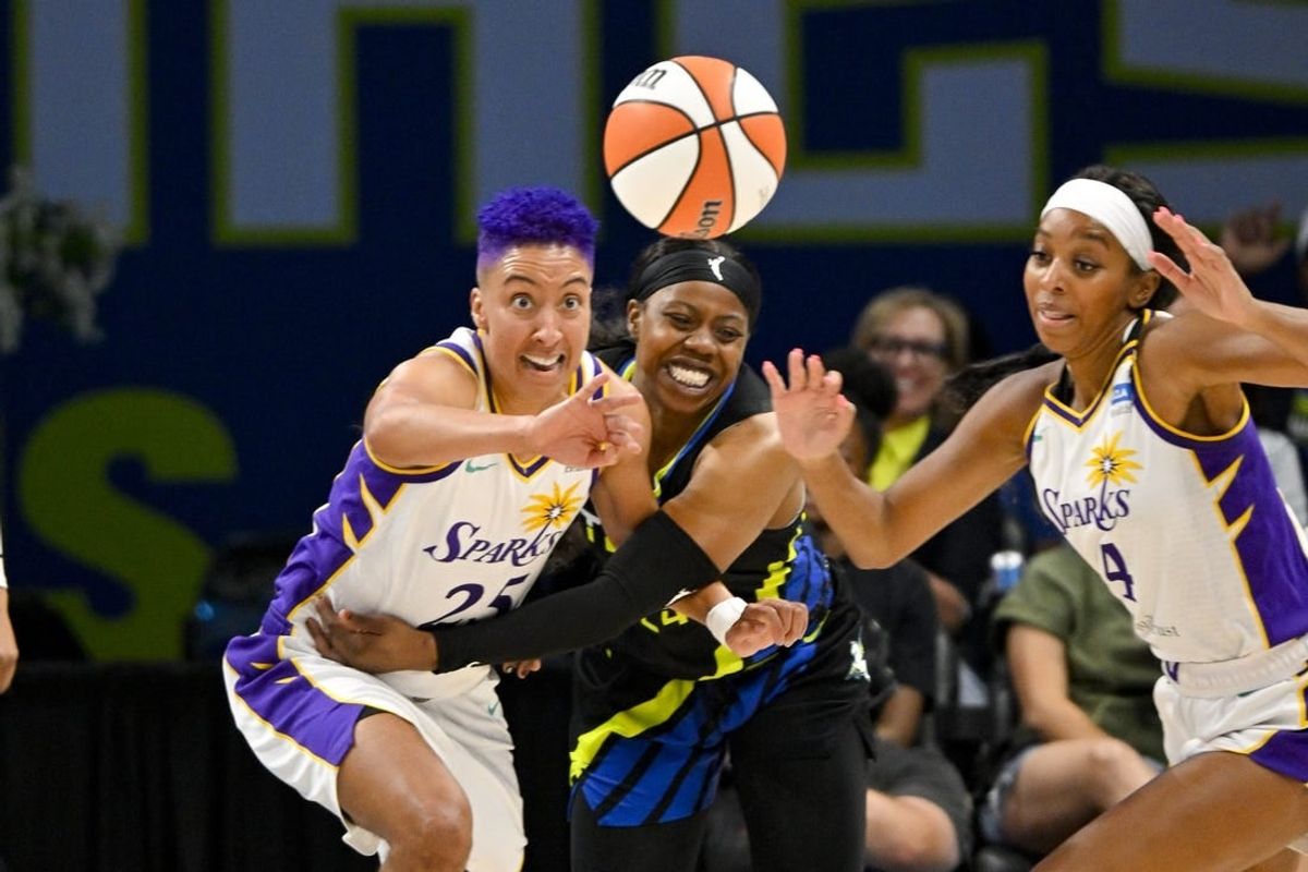 Jul 22, 2023; Arlington, Texas, USA; Los Angeles Sparks guard Layshia Clarendon (25) and guard Lexie Brown (4) and Dallas Wings guard Arike Ogunbowale (24) battle for the loose ball during the second half at College Park Center.