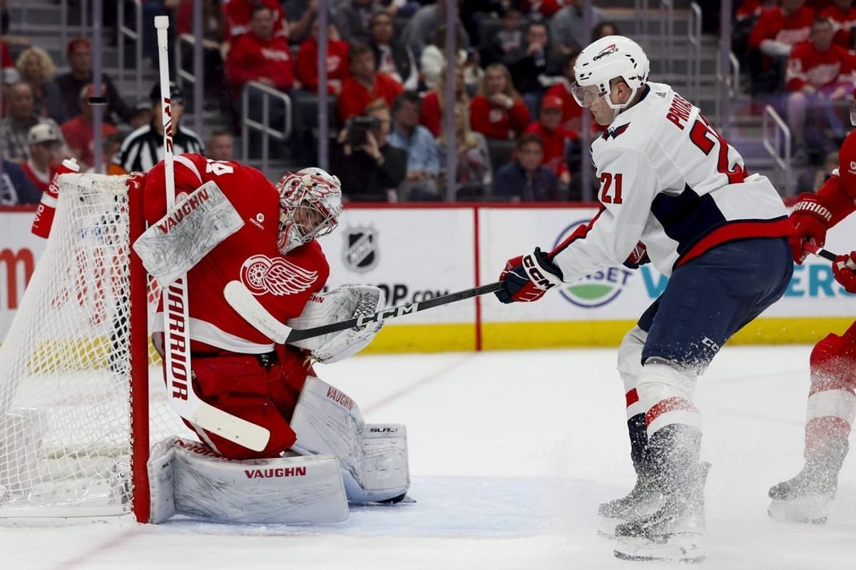Apr 9, 2024; Detroit, Michigan, USA; Detroit Red Wings goaltender Alex Lyon (34) makes a save on Washington Capitals center Aliaksei Protas (21) in the first period at Little Caesars Arena.