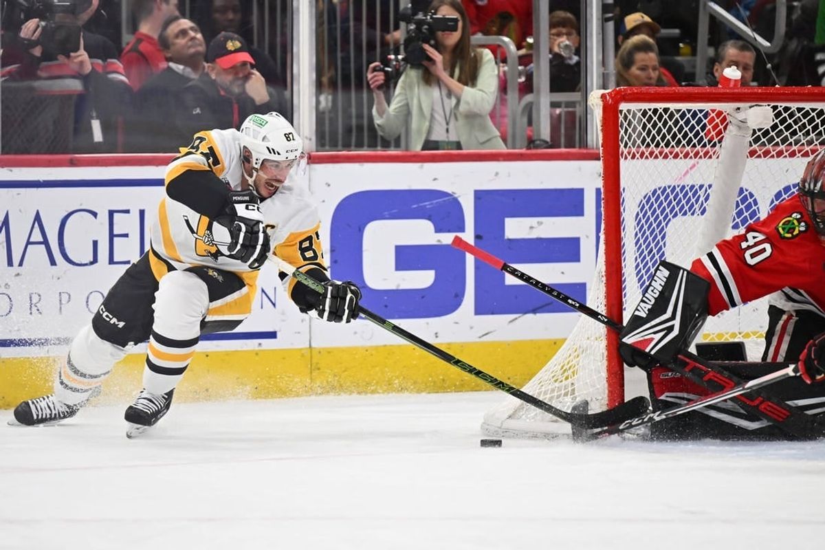 Feb 15, 2024; Chicago, Illinois, USA; Pittsburgh Penguins forward Sidney Crosby (87) attempts a shot on Chicago Blackhawks goaltender Arvid Soderblom (40) in the second period at United Center.