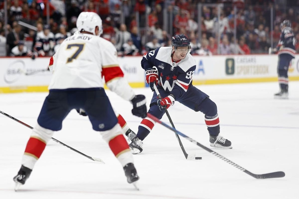 Nov 8, 2023; Washington, District of Columbia, USA;Washington Capitals center Evgeny Kuznetsov (92) skates with the puck as Florida Panthers defenseman Dmitry Kulikov (7) defends in the third period  at Capital One Arena.