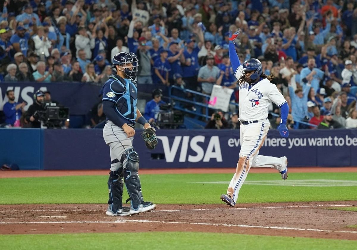 Sep 29, 2023; Toronto, Ontario, CAN; Toronto Blue Jays first baseman Vladimir Guerrero Jr. (27) runs to home plate scoring a run against the Tampa Bay Rays during the sixth inning at Rogers Centre.