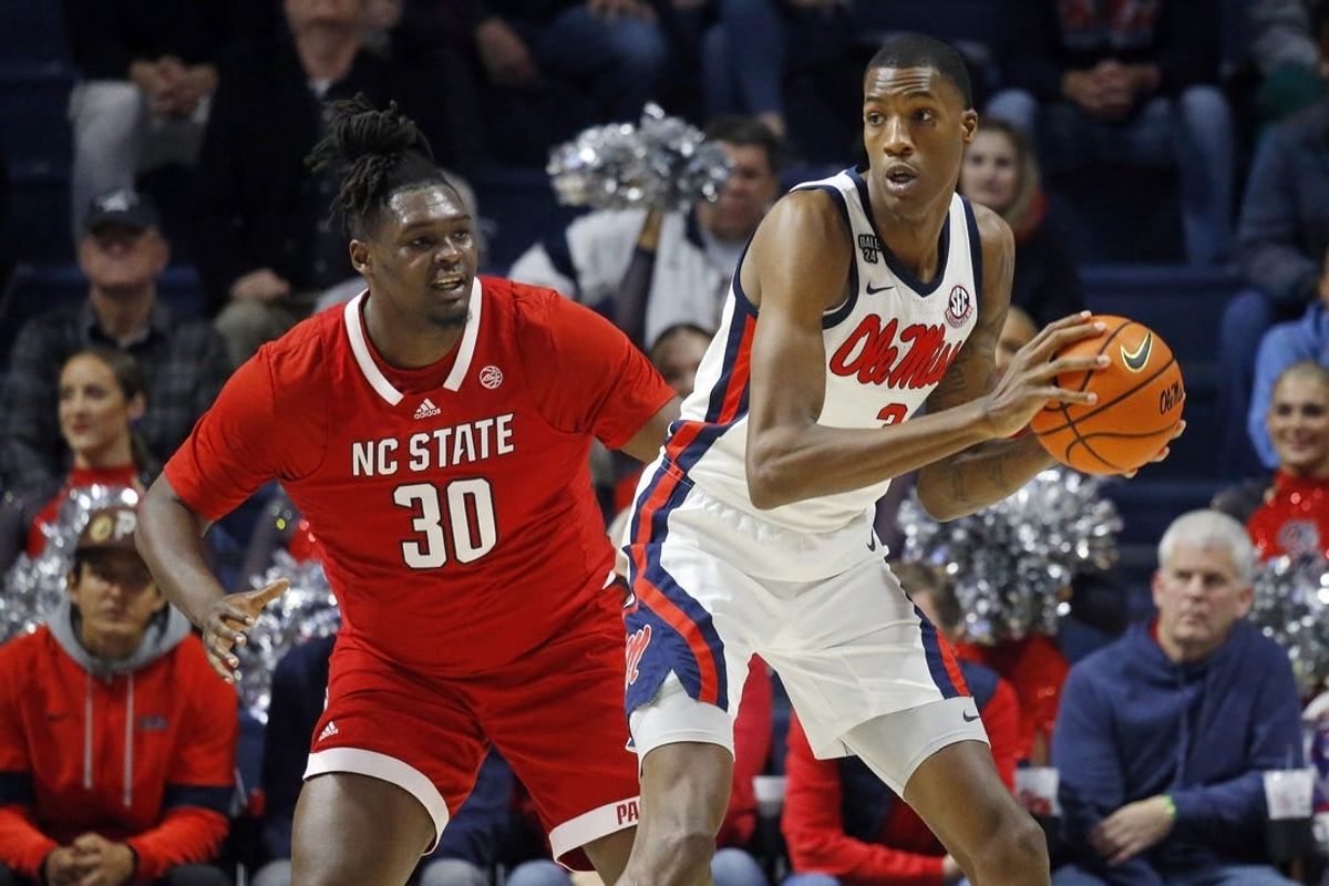 Nov 28, 2023; Oxford, Mississippi, USA; Mississippi Rebels forward Jamarion Sharp (3) handles the ball as North Carolina State Wolfpack forward DJ Burns, Jr. (30) defends during the first half at The Sandy and John Black Pavilion at Ole Miss.