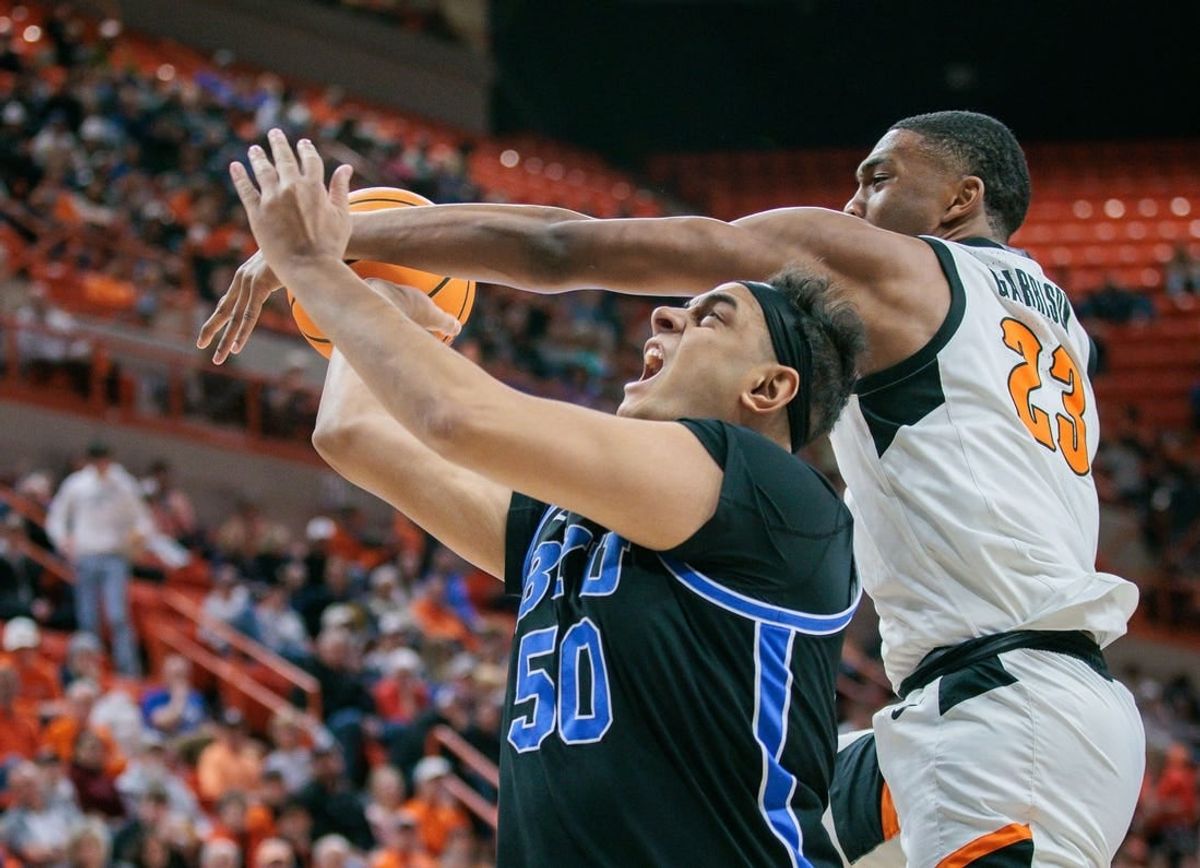 Feb 17, 2024; Stillwater, Oklahoma, USA; Oklahoma State Cowboys center Brandon Garrison (23) gets tangled up with Brigham Young Cougars center Aly Khalifa (50) during the second half at Gallagher-Iba Arena.