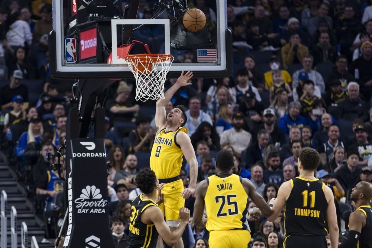 Mar 22, 2024; San Francisco, California, USA; Indiana Pacers guard T.J. McConnell (9) shoots in front of forward Jalen Smith (25) and Golden State Warriors center Trayce Jackson-Davis (32) during the first half at Chase Center.