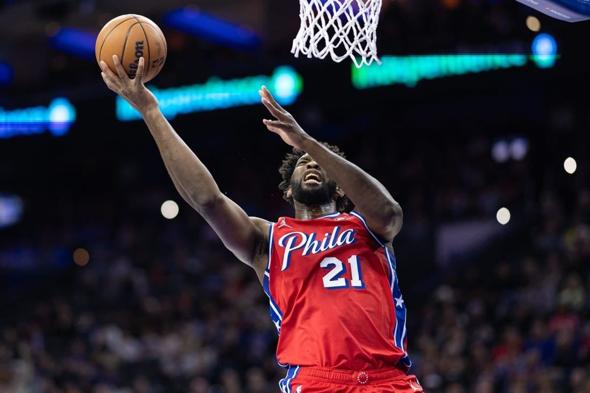 Dec 15, 2023; Philadelphia, Pennsylvania, USA; Philadelphia 76ers center Joel Embiid (21) drives for a shot against the Detroit Pistons during the first quarter at Wells Fargo Center.