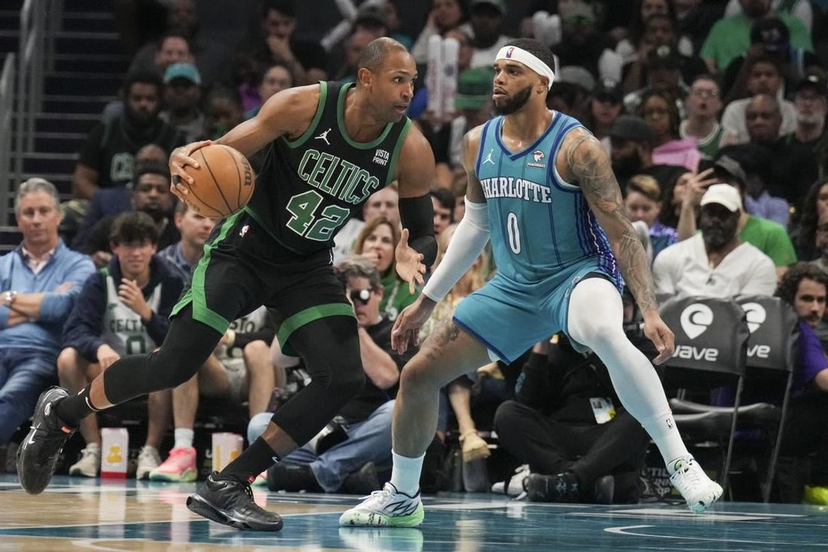 Apr 1, 2024; Charlotte, North Carolina, USA; Boston Celtics center Al Horford (42) drives against Charlotte Hornets forward Miles Bridges (0) during the second half at Spectrum Center.