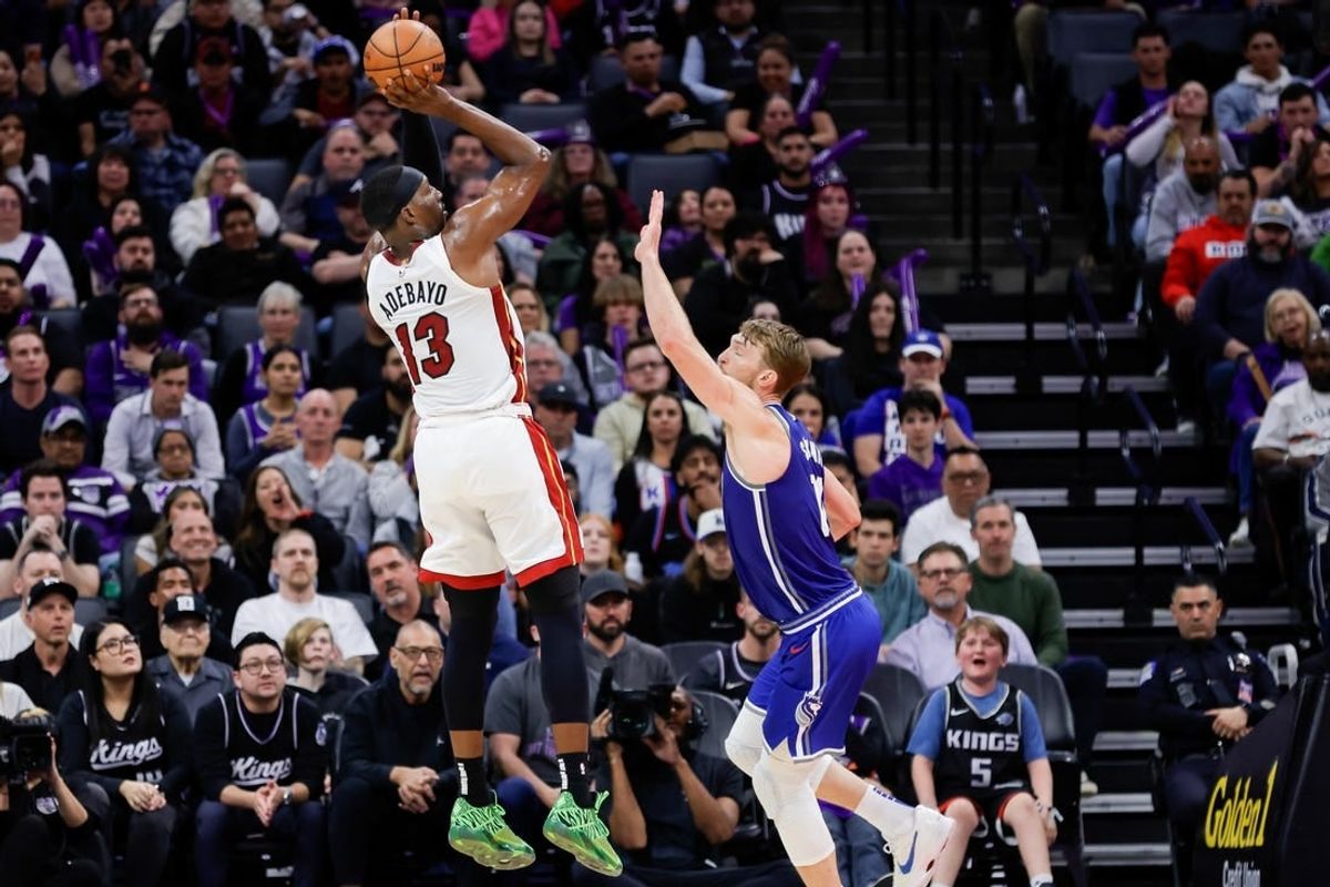Feb 26, 2024; Sacramento, California, USA; Miami Heat center Bam Adebayo (13) shoots the ball over Sacramento Kings forward Domantas Sabonis (10) during the fourth quarter at Golden 1 Center.