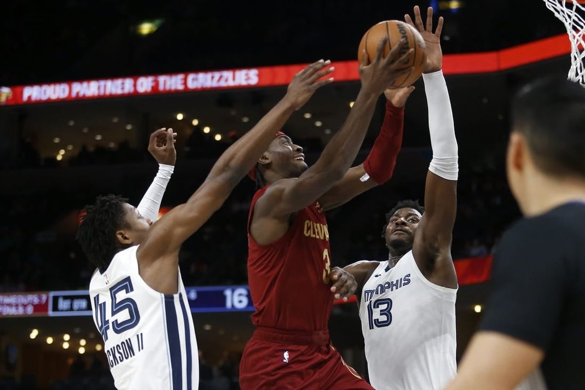 Feb 1, 2024; Memphis, Tennessee, USA; Cleveland Cavaliers guard Caris LeVert (3) drives to the basket between Memphis Grizzlies forward GG Jackson (45) and forward-center Jaren Jackson Jr. (13) during the first half at FedExForum.