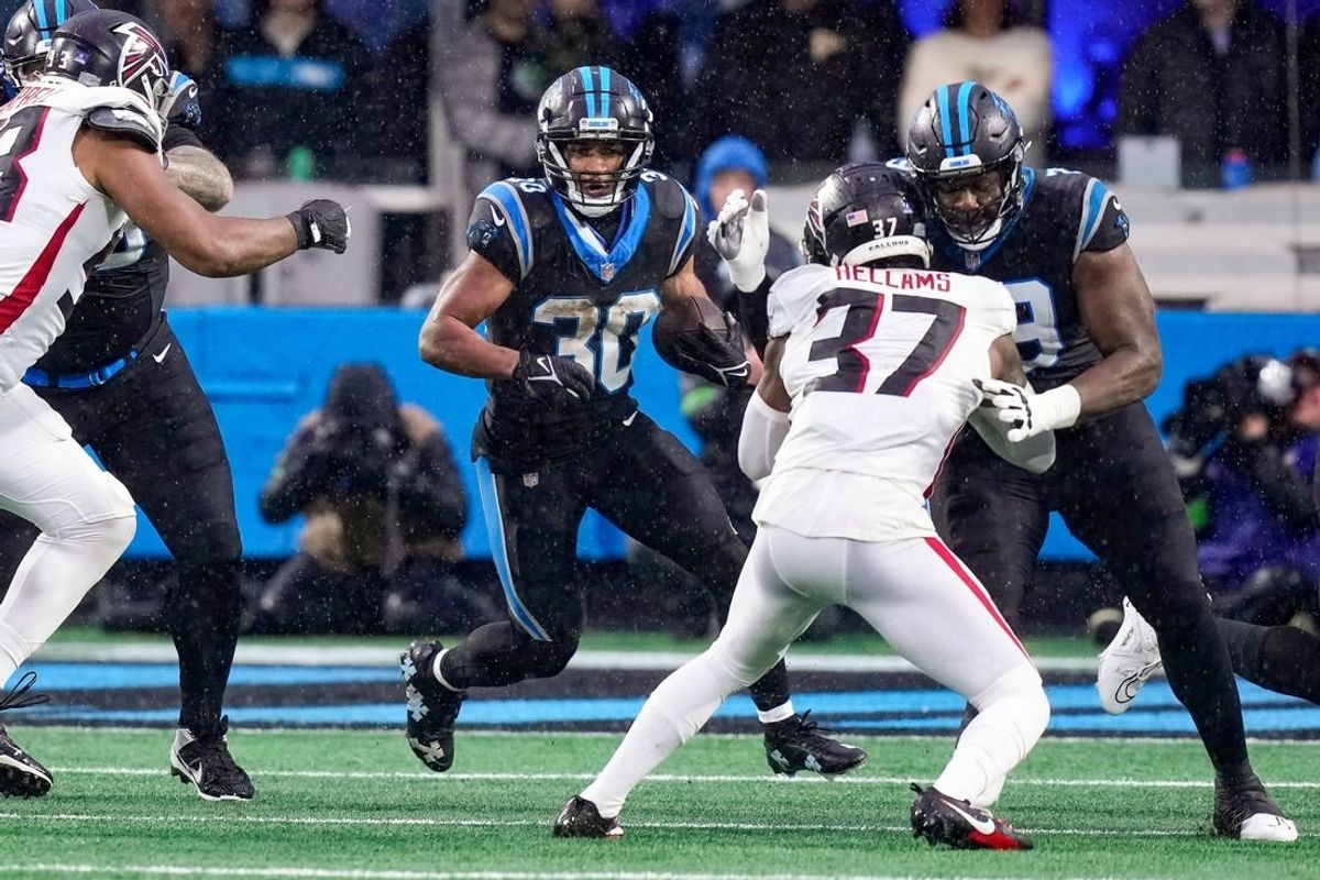 Dec 17, 2023; Charlotte, North Carolina, USA; Carolina Panthers running back Chuba Hubbard (30) runs the ball against the Atlanta Falcons during the second quarter at Bank of America Stadium.