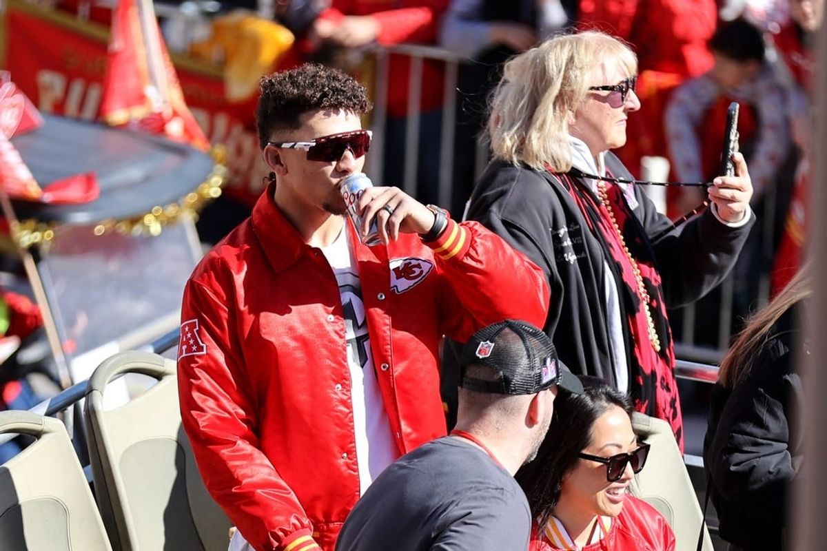 Feb 14, 2024; Kansas City, MO, USA; Kansas City Chiefs quarterback Patrick Mahomes (15) and Donna Kelce celebrate on the bus in the parade during the celebration of the Kansas City Chiefs winning Super Bowl LVIII.