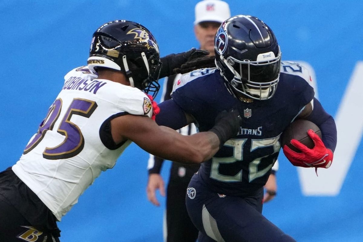 Oct 15, 2023; London, United Kingdom; Tennessee Titans running back Derrick Henry (22) carries the ball against Baltimore Ravens linebacker Tavius Robinson (95) in the second half during an NFL International Series game at Tottenham Hotspur Stadium.