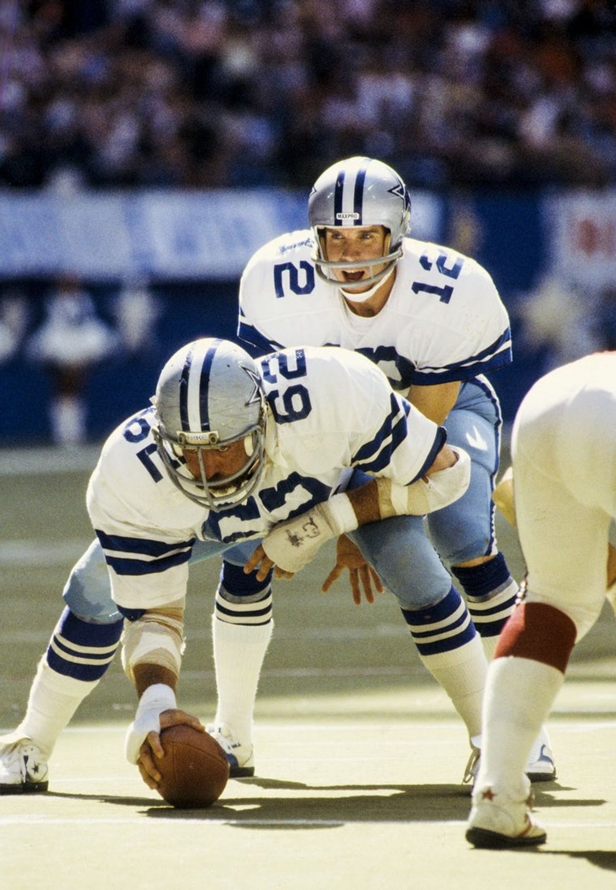 Oct 21, 1979; Irving, TX, USA; FILE PHOTO; Dallas Cowboys quarterback Roger Staubach (12) lined up under center John Fitzgerald (62) against the St. Louis Cardinals at Texas Stadium. Mandatory Credit Herb Weitman-Imagn Images