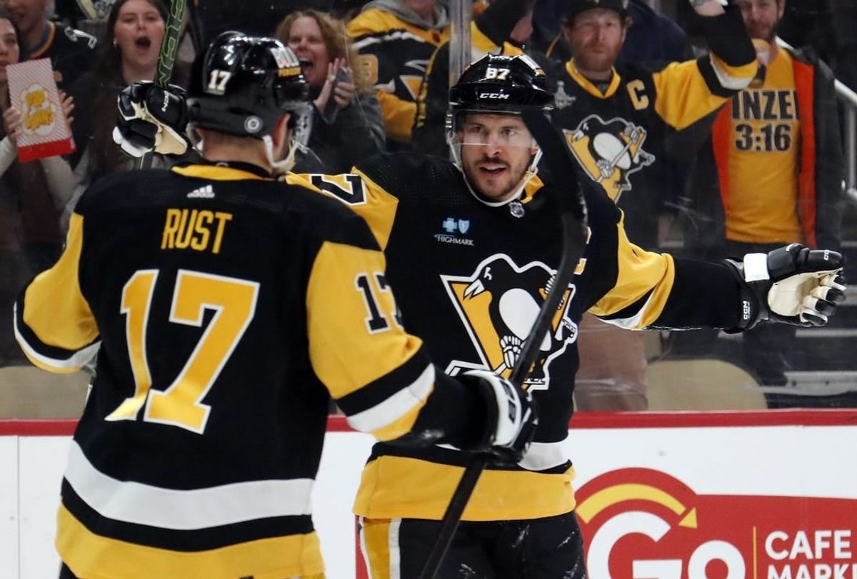 Apr 15, 2024; Pittsburgh, Pennsylvania, USA;  Pittsburgh Penguins right wing Bryan Rust (17) congratulates center Sidney Crosby (87) on his goal against the Nashville Predators during the first period at PPG Paints Arena.