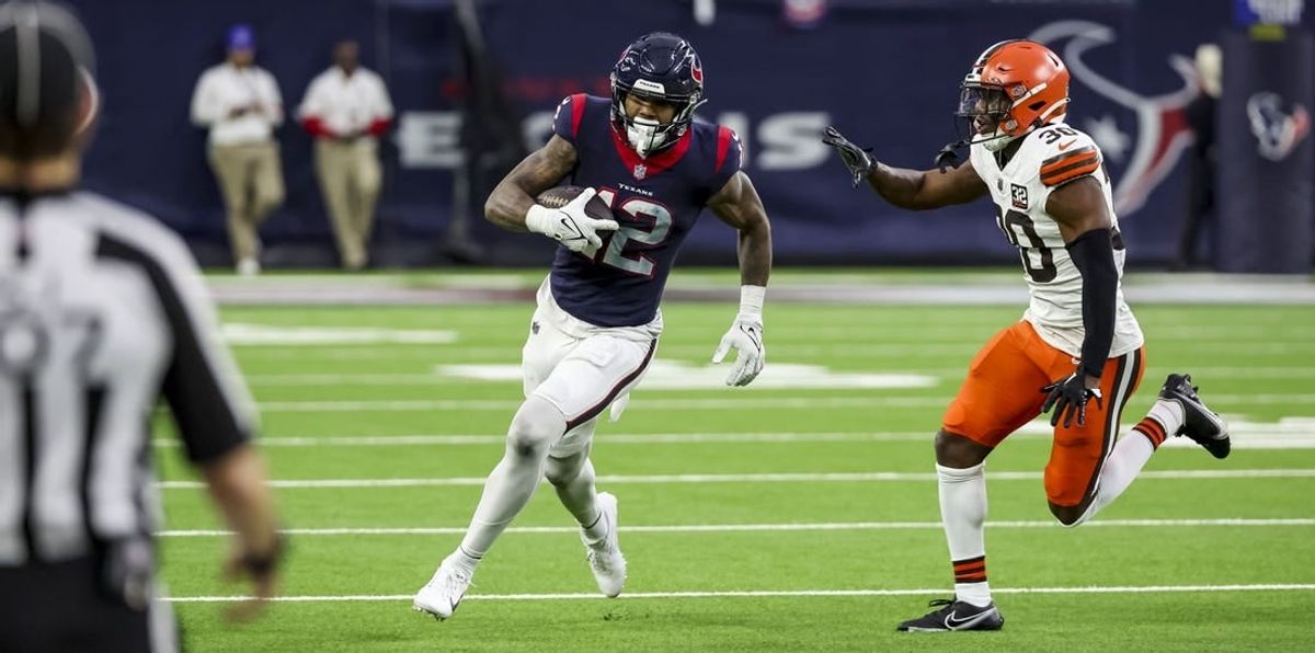 Jan 13, 2024; Houston, Texas, USA; Houston Texans wide receiver Nico Collins (12) runs with the ball during the second quarter in a 2024 AFC wild card game at NRG Stadium.