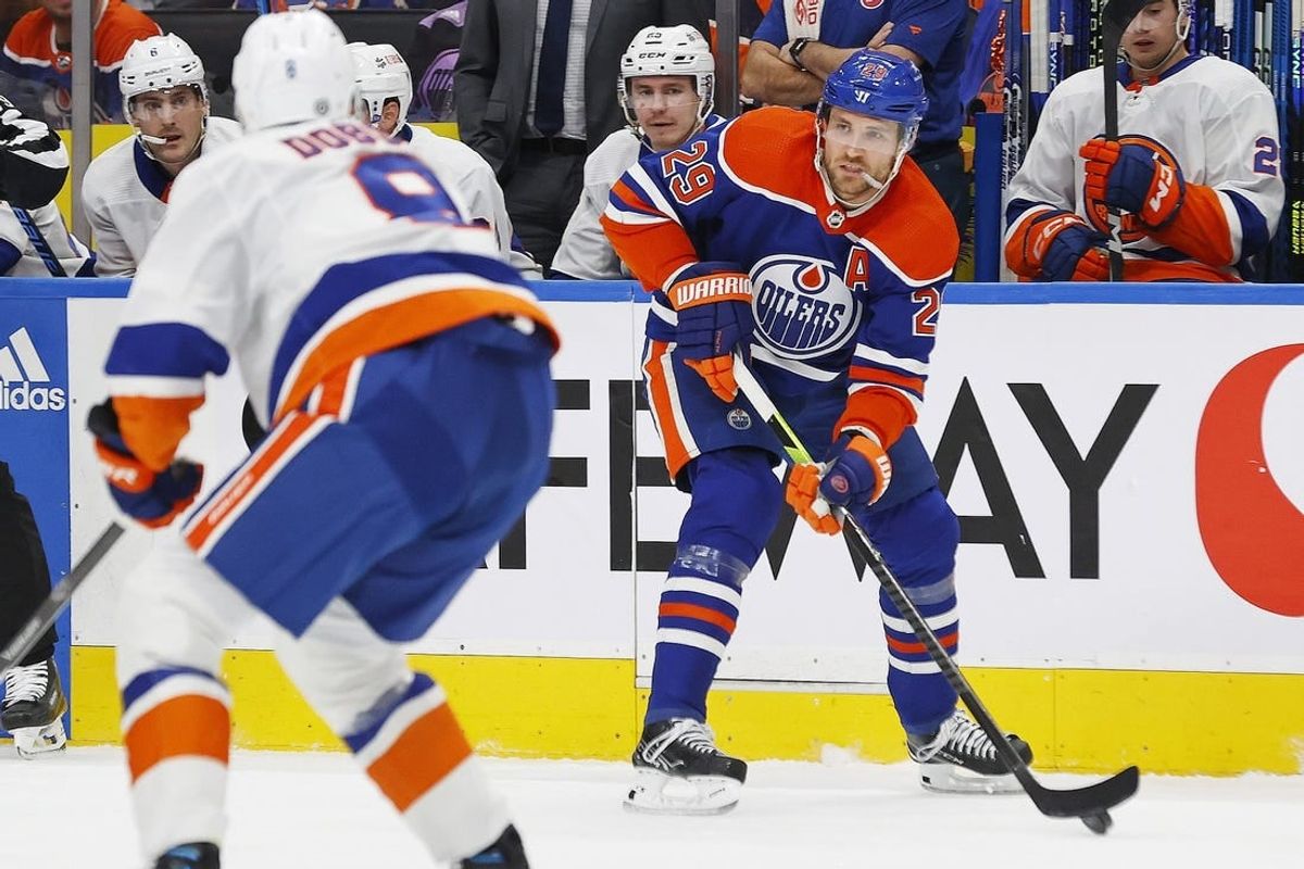 Nov 13, 2023; Edmonton, Alberta, CAN; Edmonton Oilers forward Leon Draisaitl (29) looks to make a pass in front of New York Islanders defensemen Noah Dobson (8) during the first period at Rogers Place.