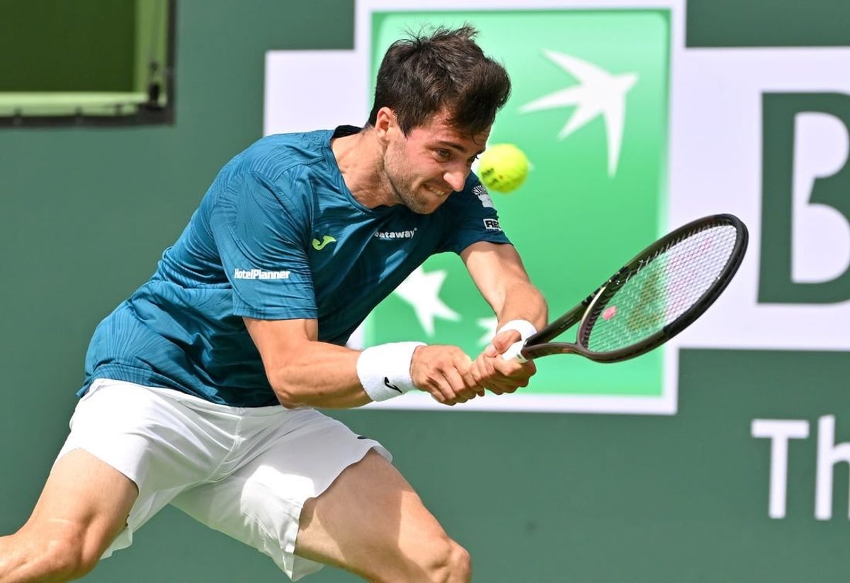 Mar 11, 2023; Indian Wells, CA, USA;  Pedro Martinez (ESP) hits a shot in his second round match against Felix Auger-Aliassime (CAN)  in the BNP Paribas Open at the Indian Wells Tennis Garden.