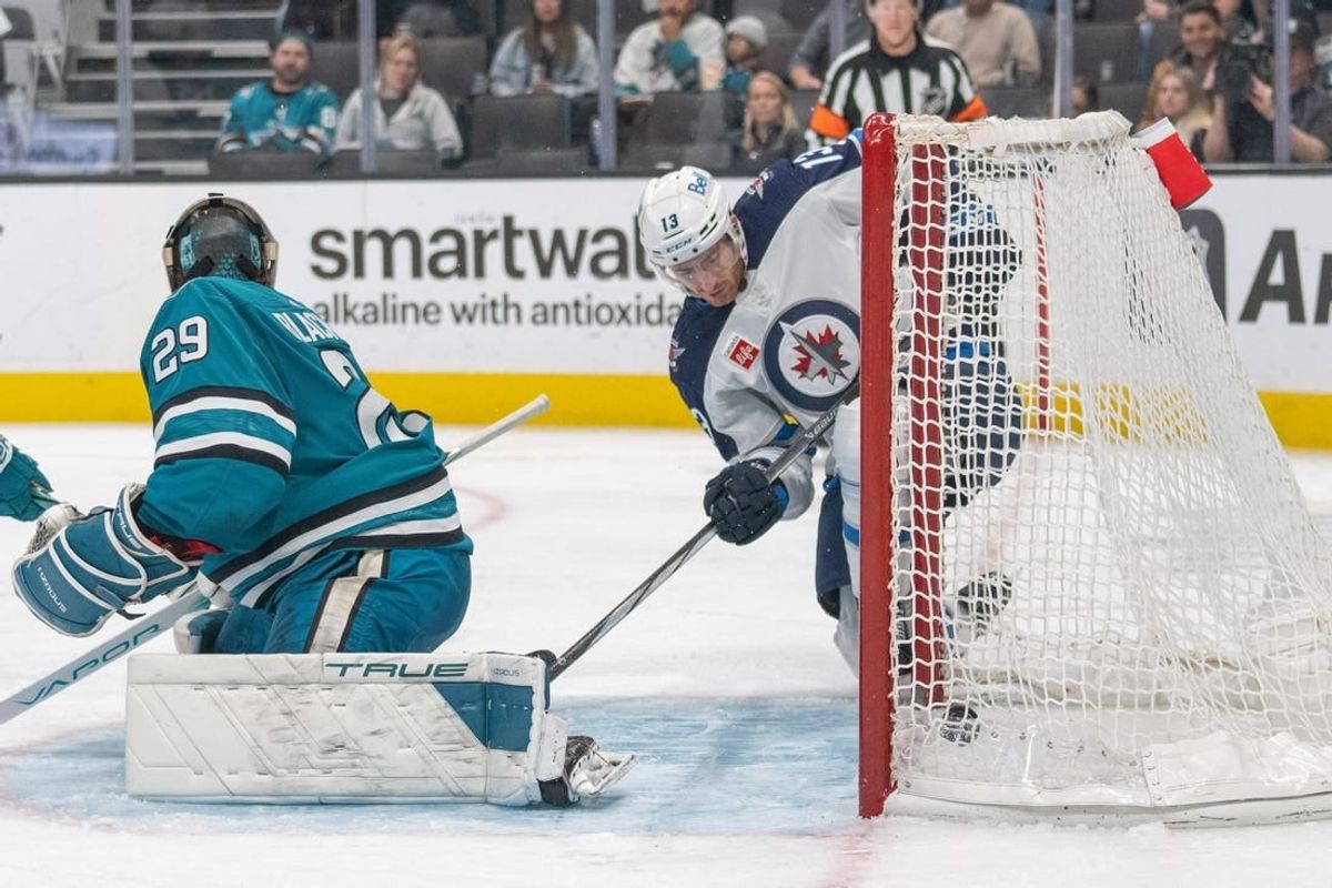 Jan 4, 2024; San Jose, California, USA; Winnipeg Jets center Gabriel Vilardi (13) deflects the puck into the goal during the third period against San Jose Sharks goaltender Mackenzie Blackwood (29) at SAP Center at San Jose.