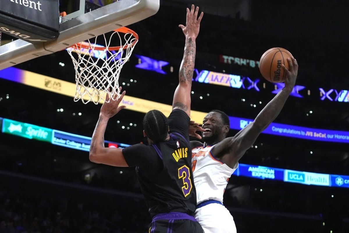 Dec 18, 2023; Los Angeles, California, USA; New York Knicks forward Julius Randle (30) shoots the ball against Los Angeles Lakers forward Anthony Davis (3) at Crypto.com Arena.