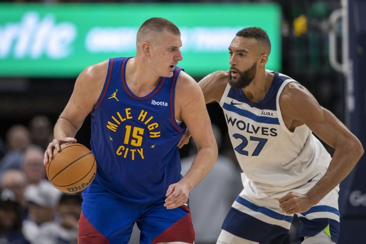 May 10, 2024; Minneapolis, Minnesota, USA; Denver Nuggets center Nikola Jokic (15) controls the ball as Minnesota Timberwolves center Rudy Gobert (27) defends in the second half during game three of the second round for the 2024 NBA playoffs at Target Center.