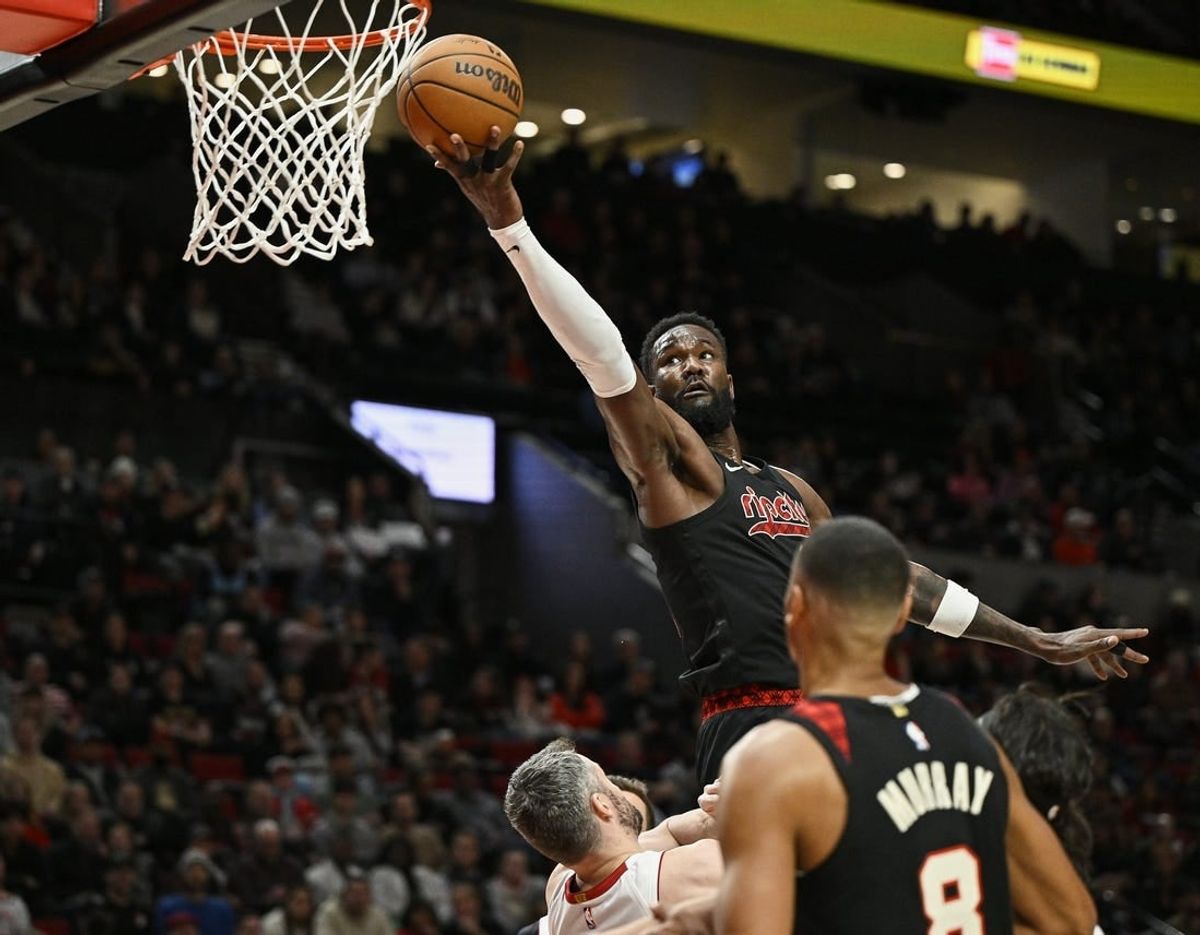 Feb 27, 2024; Portland, Oregon, USA; Portland Trail Blazers center Deandre Ayton (2) scores a basket during the first half against Miami Heat forward Kevin Love (42) at Moda Center.
