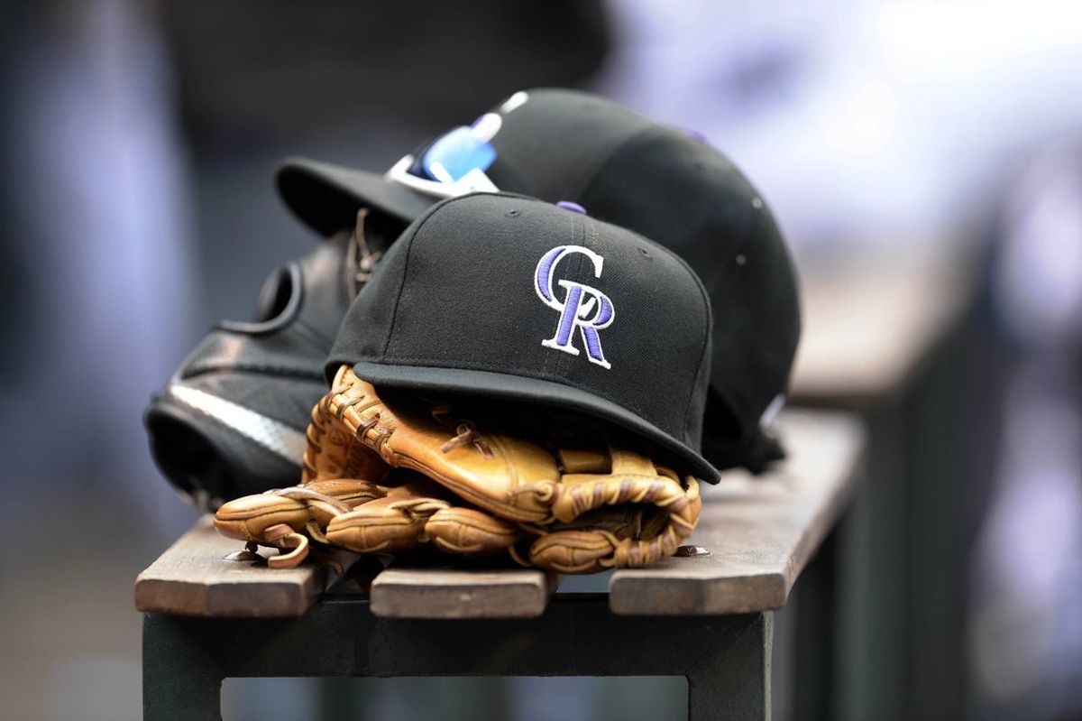 Apr 10, 2015; Denver, CO, USA; General view of Colorado Rockies hats and gloves during the eighth inning against the Chicago Cubs at Coors Field. The Rockies defeated the Cubs 5-1. Mandatory Credit: Ron Chenoy-Imagn Images