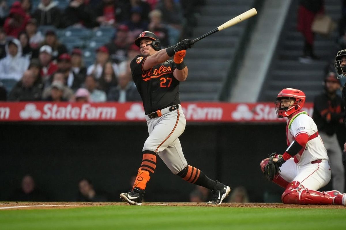 Apr 22, 2024; Anaheim, California, USA; Baltimore Orioles catcher James McCann (27) follows through on a solo home run in the second inning against the Los Angeles Angels at Angel Stadium.