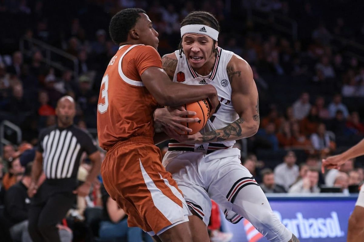 Nov 19, 2023; New York, New York, USA; Texas Longhorns guard Max Abmas (3) ties up Louisville Cardinals guard Tre White (22) during the second half at Madison Square Garden.