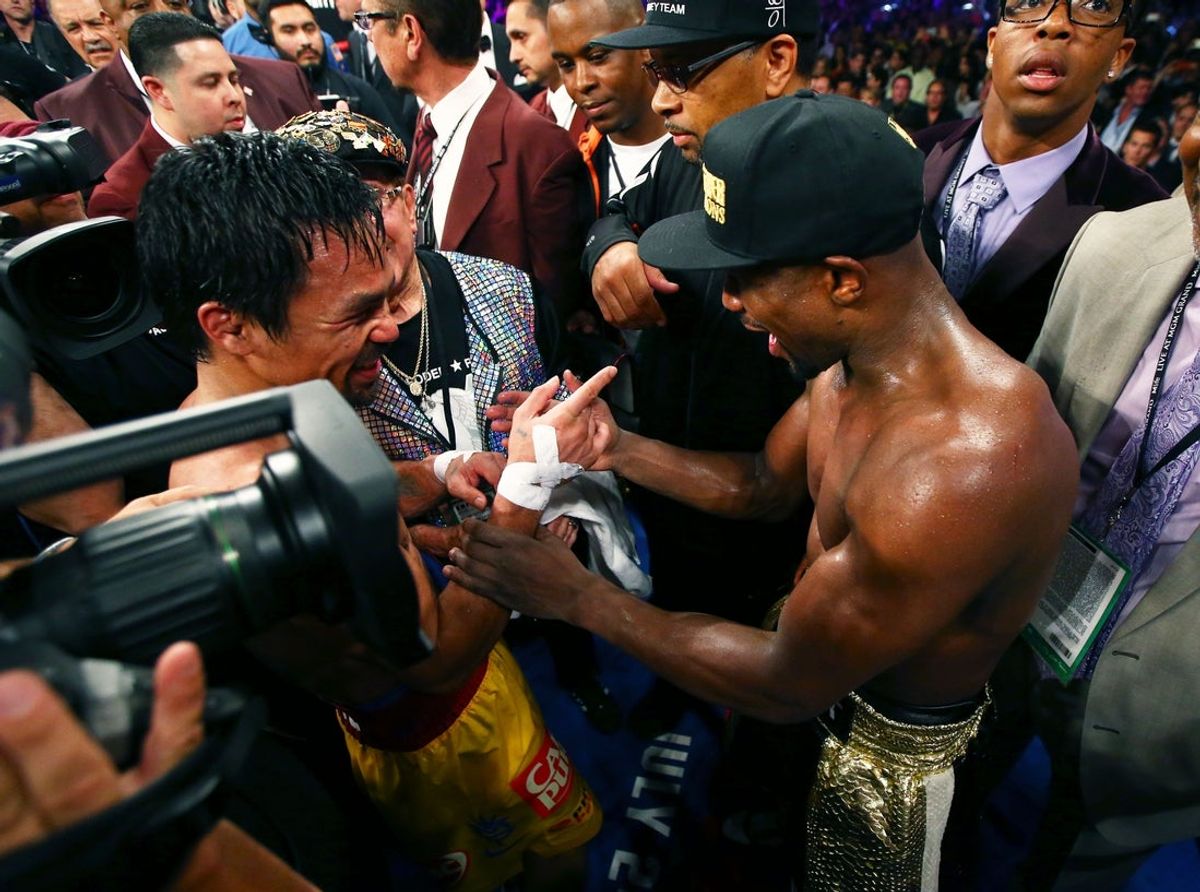 May 2, 2015; Las Vegas, NV, USA; Floyd Mayweather (right) talks with Manny Pacquiao as celebrates after his welterweight championship bout at MGM Grand Garden Arena. Mandatory Credit: Mark J. Rebilas-Imagn Images