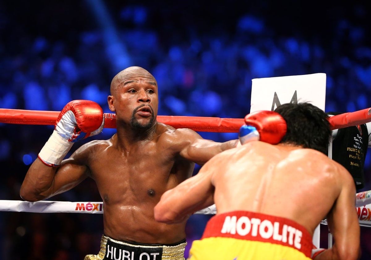 May 2, 2015; Las Vegas, NV, USA; Floyd Mayweather (left) punches Manny Pacquiao during a world welterweight championship bout at MGM Grand Garden Arena. Mandatory Credit: Mark J. Rebilas-Imagn Images