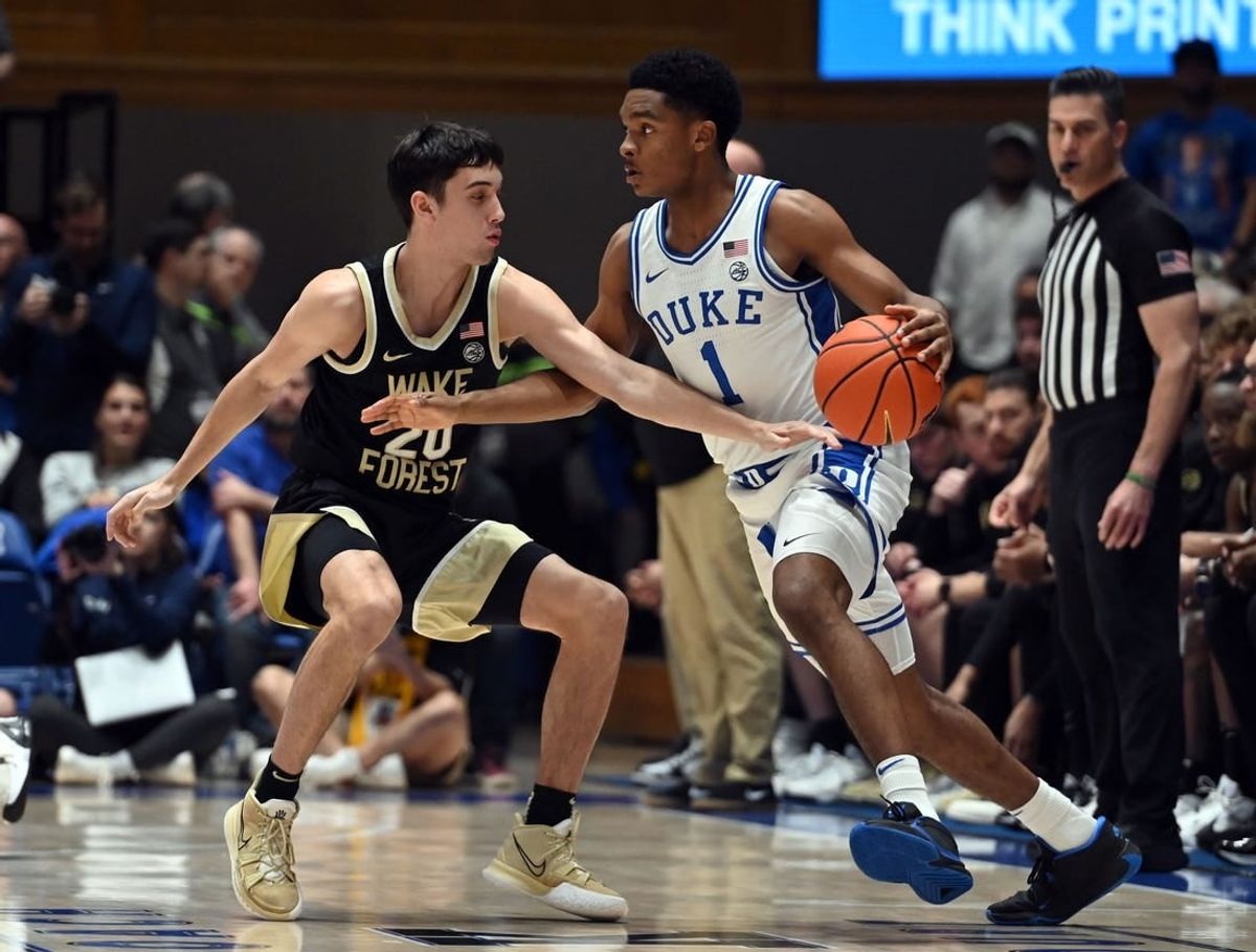 Feb 12, 2024; Durham, North Carolina, USA;  Duke Blue Devils guard Caleb Foster (1) controls the ball in front of Wake Forest Deamon Deacons guard Parker Friedrichsen (20) during the first half at Cameron Indoor Stadium.