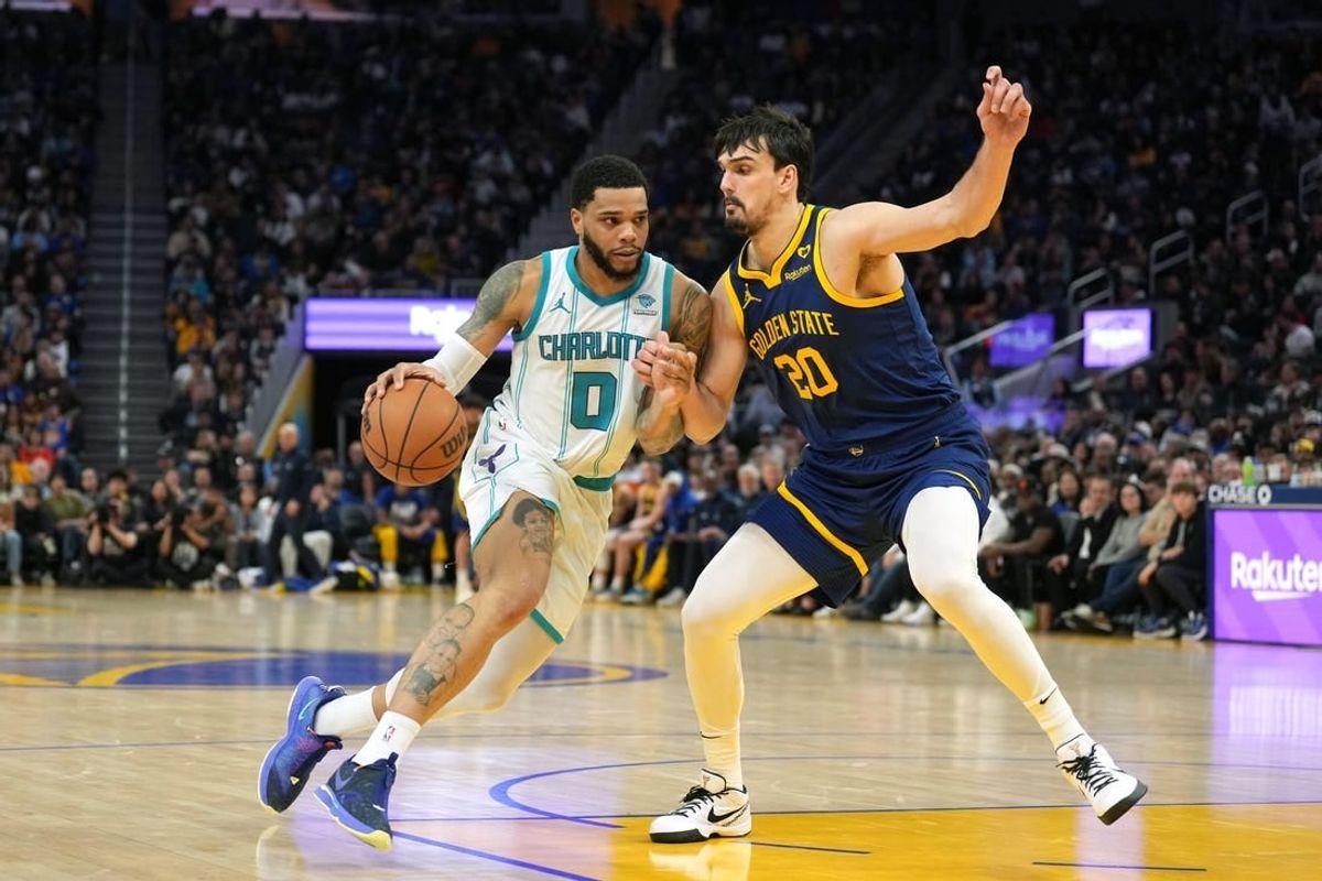 Feb 23, 2024; San Francisco, California, USA; Charlotte Hornets forward Miles Bridges (0) dribbles against Golden State Warriors forward Dario Saric (20) during the fourth quarter at Chase Center.