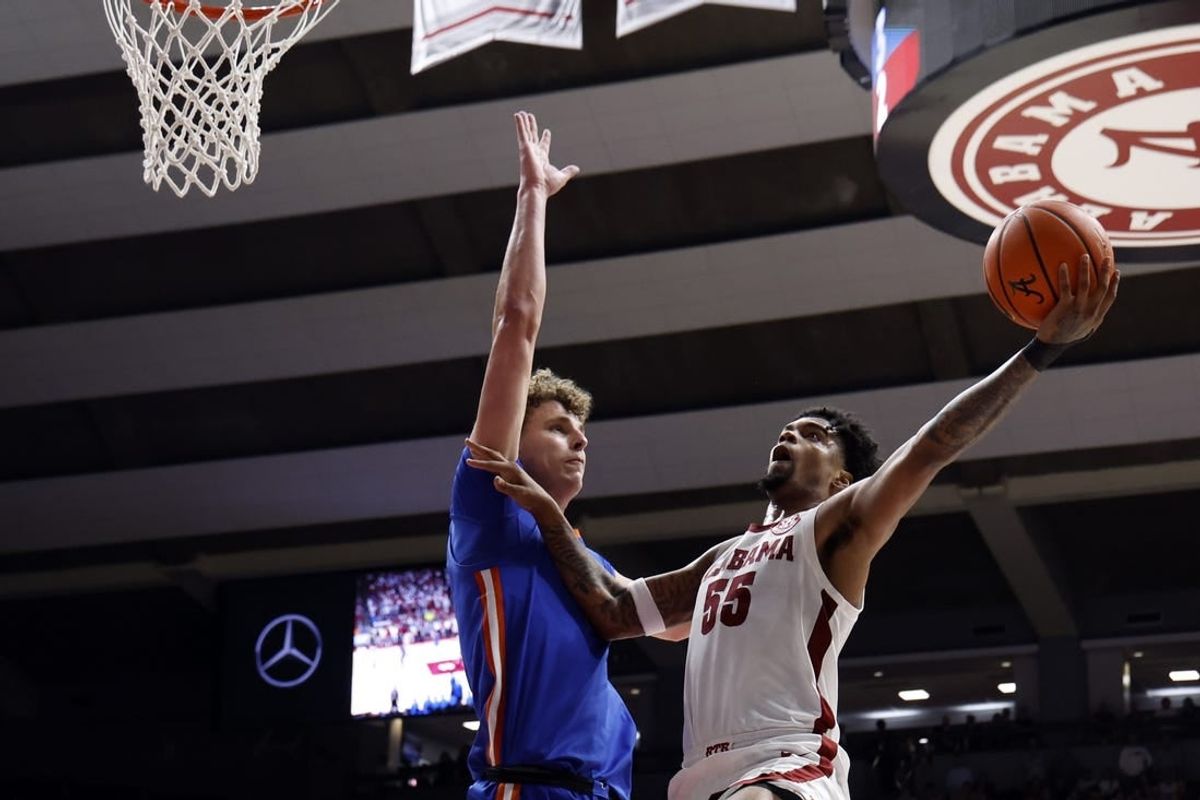 Feb 21, 2024; Tuscaloosa, Alabama, USA; Alabama Crimson Tide guard Aaron Estrada (55) shoots as Florida Gators center Micah Handlogten (3) defends during the first half at Coleman Coliseum.