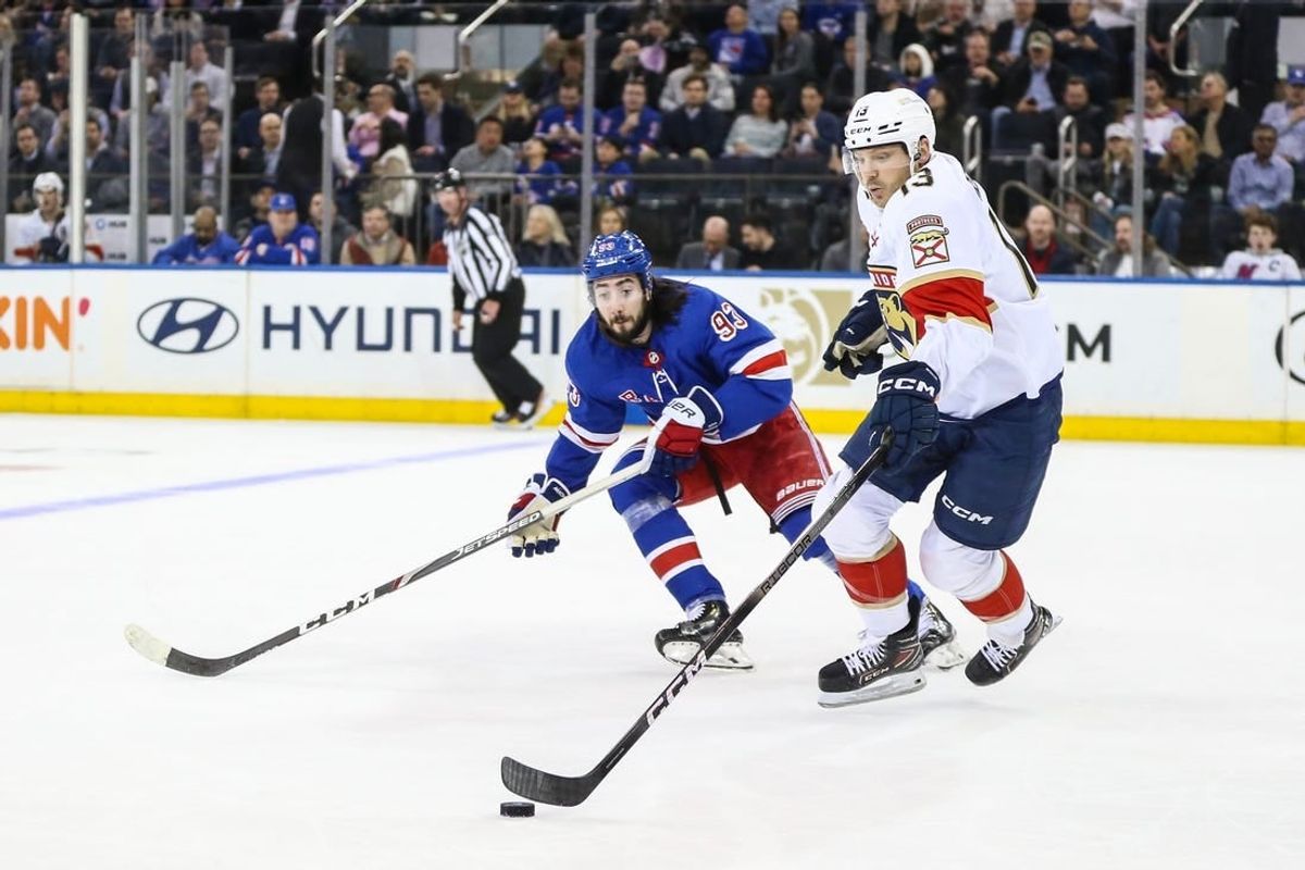 Mar 4, 2024; New York, New York, USA;  New York Rangers center Mika Zibanejad (93) and Florida Panthers center Sam Reinhart (13) chases the puck in the first period at Madison Square Garden.