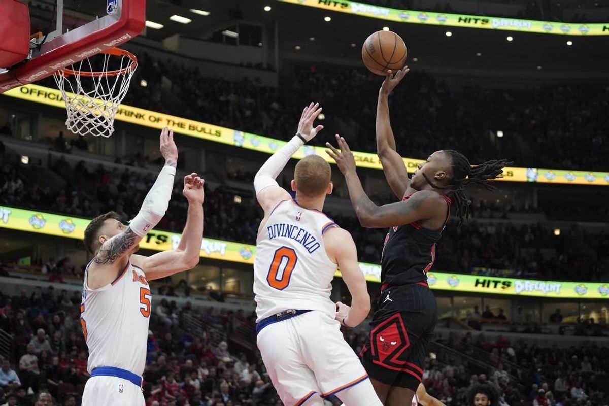 Apr 5, 2024; Chicago, Illinois, USA; New York Knicks guard Donte DiVincenzo (0) defends Chicago Bulls guard Ayo Dosunmu (12)  during the first quarter at United Center.