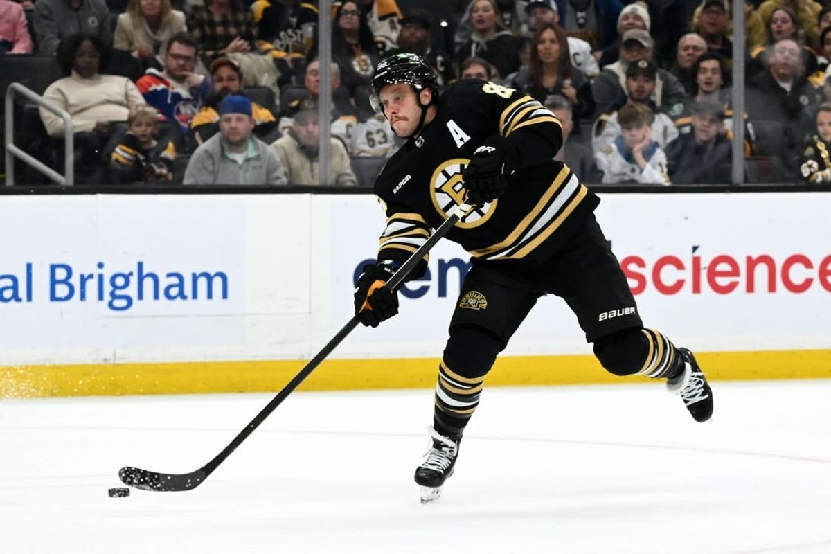 Nov 9, 2023; Boston, Massachusetts, USA; Boston Bruins right wing David Pastrnak (88) takes a shot against the New York Islanders during the third period at the TD Garden.