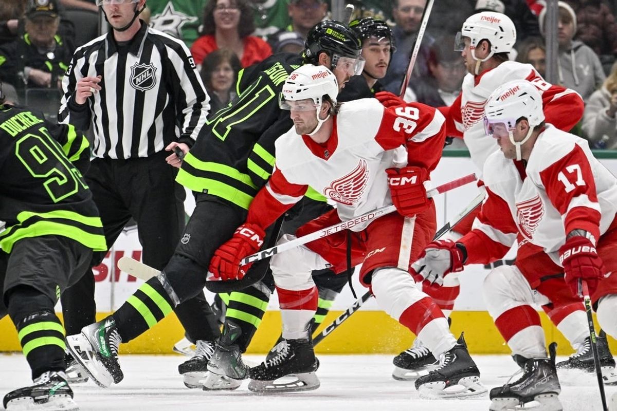 Dec 11, 2023; Dallas, Texas, USA; Dallas Stars center Tyler Seguin (91) and Detroit Red Wings right wing Christian Fischer (36) battle for control of the puck during the first period at the American Airlines Center.