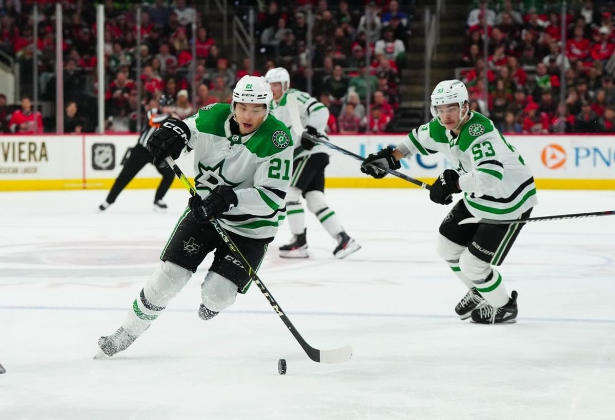 Feb 24, 2024; Raleigh, North Carolina, USA;  Dallas Stars left wing Jason Robertson (21) skates with the puck next to center Wyatt Johnston (53) during the second period against the Carolina Hurricanes at PNC Arena.