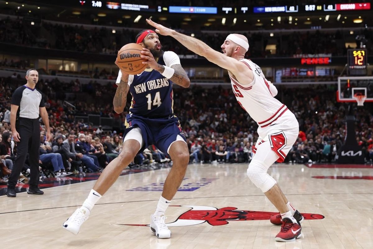 Dec 2, 2023; Chicago, Illinois, USA; New Orleans Pelicans forward Brandon Ingram (14) looks to shoot against Chicago Bulls guard Alex Caruso (6) during the first half at United Center.