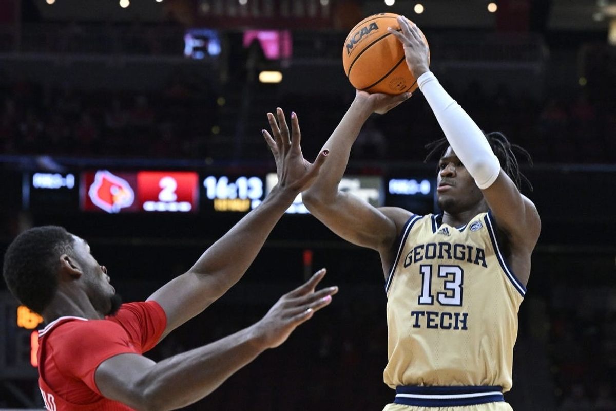 Feb 10, 2024; Louisville, Kentucky, USA; Georgia Tech Yellow Jackets guard Miles Kelly (13) shoots against Louisville Cardinals forward Brandon Huntley-Hatfield (5) during the first half at KFC Yum! Center.
