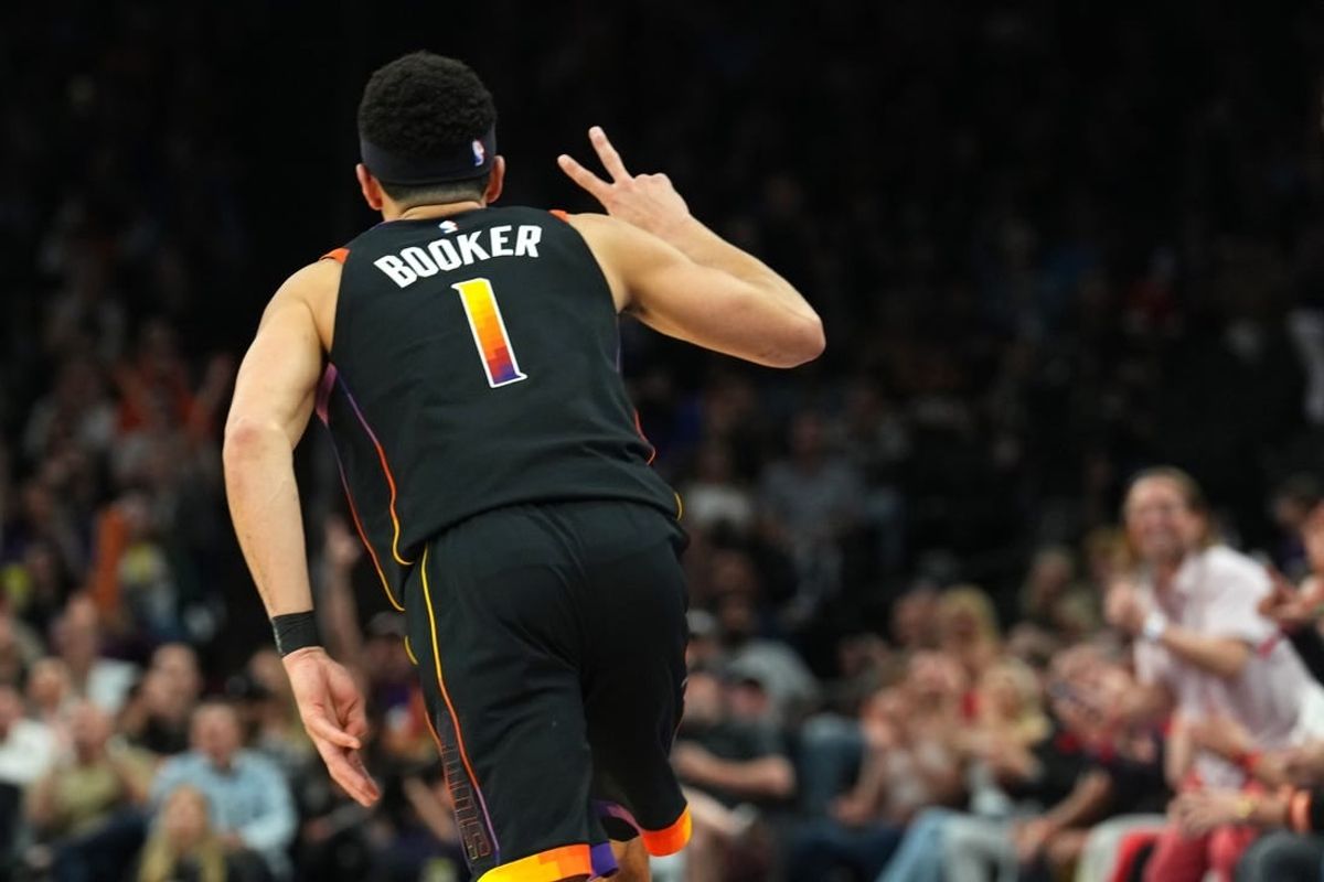 Apr 3, 2024; Phoenix, Arizona, USA; Phoenix Suns guard Devin Booker (1) reacts after making a three point basket against the Cleveland Cavaliers during the first half at Footprint Center.